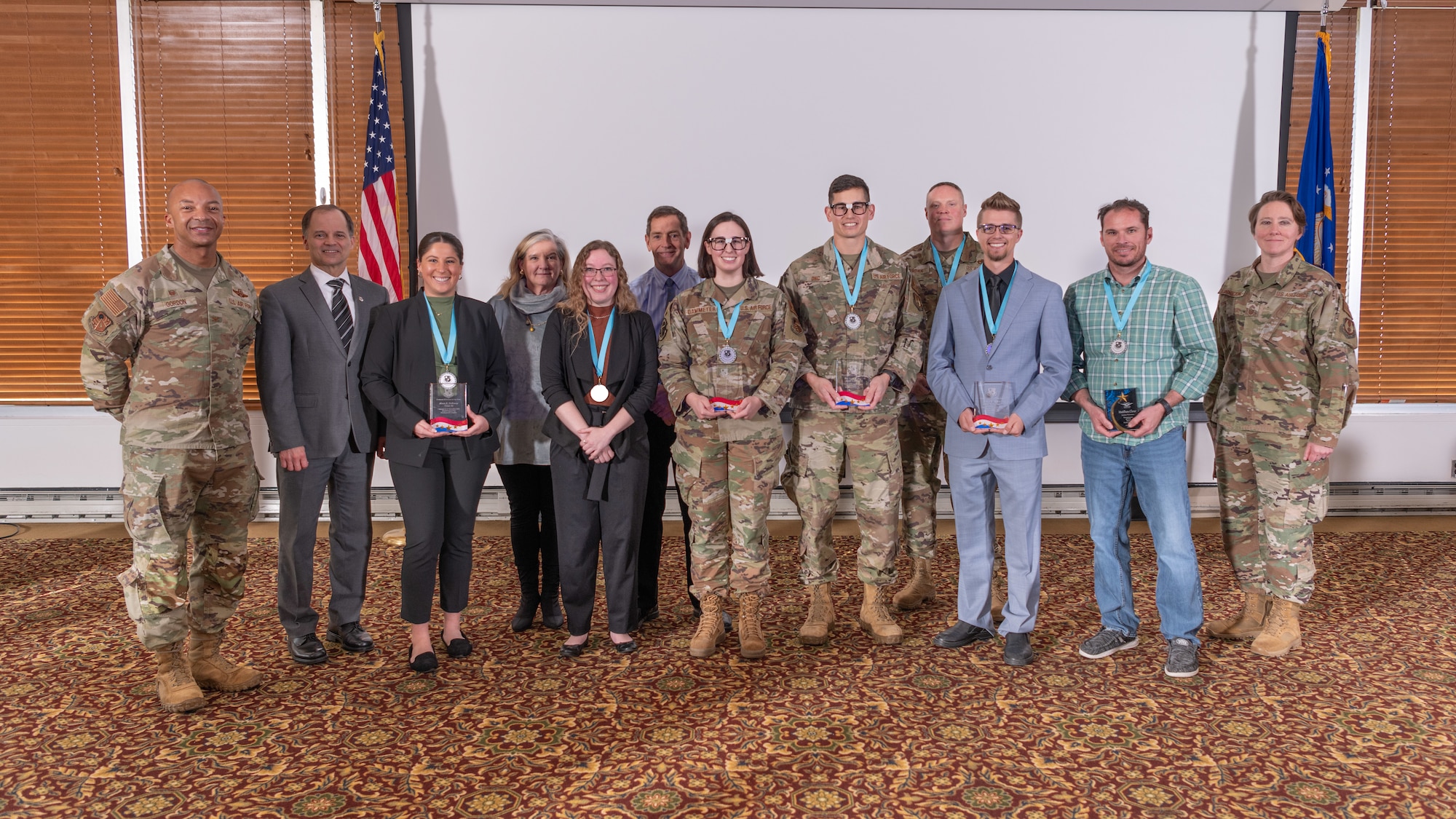 Arnold Engineering Development Complex annual award winners pose for a photo Feb. 15, 2024, at Arnold Air Force Base, Tenn., with AEDC Commander Col. Randel Gordon, left, AEDC Senior Enlisted Leader Chief Master Sgt. Jennifer Cirricione, right, Senior Technical Director Ed Tucker, second from left, Chief of Complex Support Sarah Beth Morgan, fourth from left, and AEDC Deputy Director Kevin Muckerheide, fifth from left. Award winners pictured from left are Alexis Holloway, Bethany Hill, 1st Lt. Camden Dammeyer, Maj. Justin Ong, Senior Master Sgt. James Jordan, Joshua Anders and Matthew Clear. (U.S. Air Force photo by Keith Thornburgh)