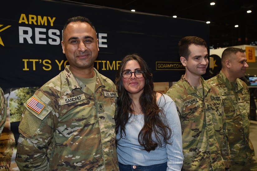 Sgt. Amrit Sandhu, left, G-8, Finance, 85th U. S. Army Reserve Support Command and his friend pause for a photo, following a re-enlistment ceremony that Sandhu participated in during the Chicago Auto Show at McCormick Place.