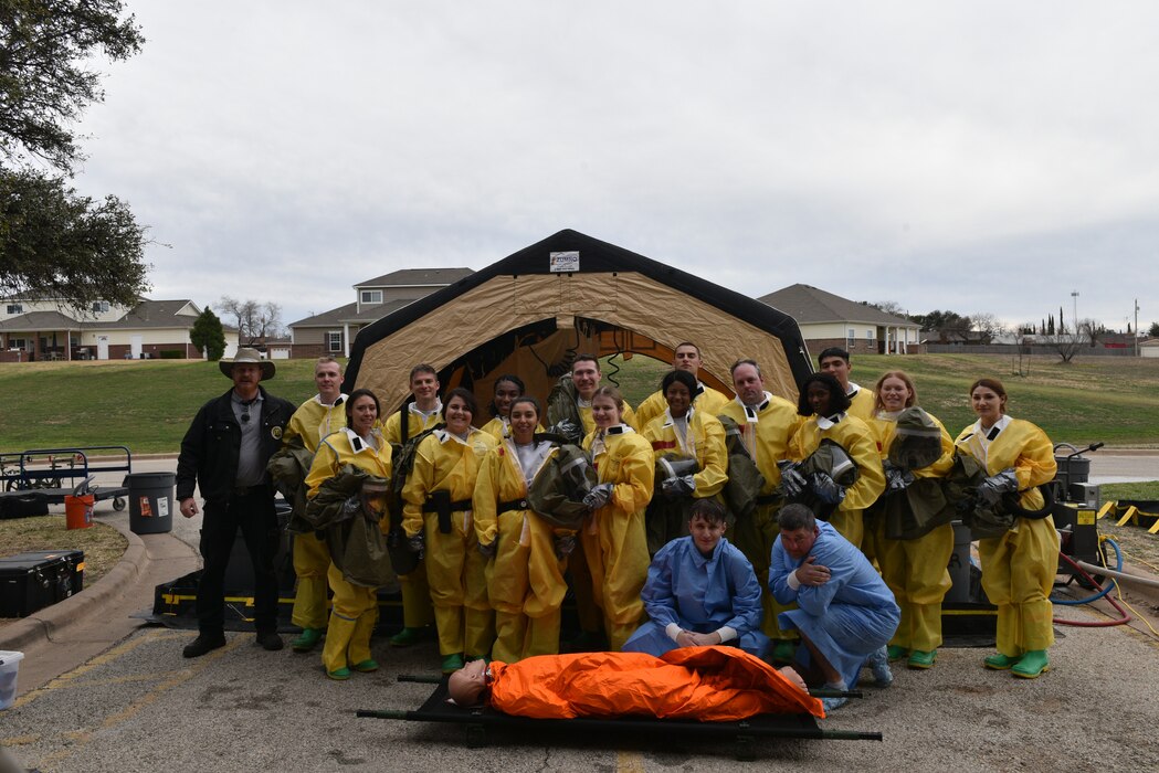 Members assigned to the 17th Medical Group pose for a picture following their Integrated in-place patient decontamination training at Goodfellow Air Force Base, Texas, Feb. 8, 2023. DECON training aims to inform first responders and hospital staff members, who would be the first to respond or provide care, and what steps need to be taken to ensure safety. (U.S. Air Force photo by 2nd Lt. Kayunna Holt)