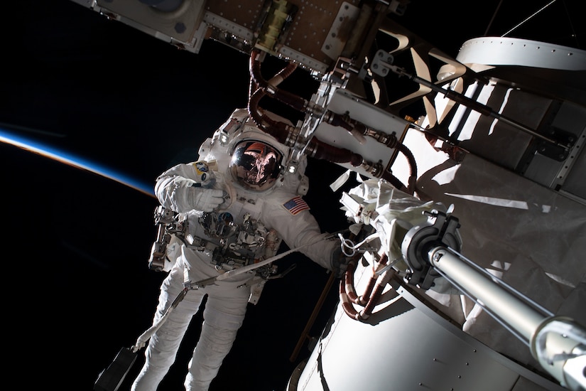 An astronaut does a spacewalk in Earth’s orbit.