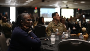 U.S. Navy Chief Petty Officer Dustin Shed, CNATTU Learning Site senior enlisted advisor, gives a speech as other military members listen during the Black History Month luncheon at the Powell Event Center, Goodfellow Air Force Base, Texas, Feb. 16, 2024. National Black History Month has its origins in 1915 when historian and author Dr. Carter G. Woodson founded the Association for the Study of Negro Life and History. (U.S. Air Force Photo by Staff Sgt. Nathan Call)