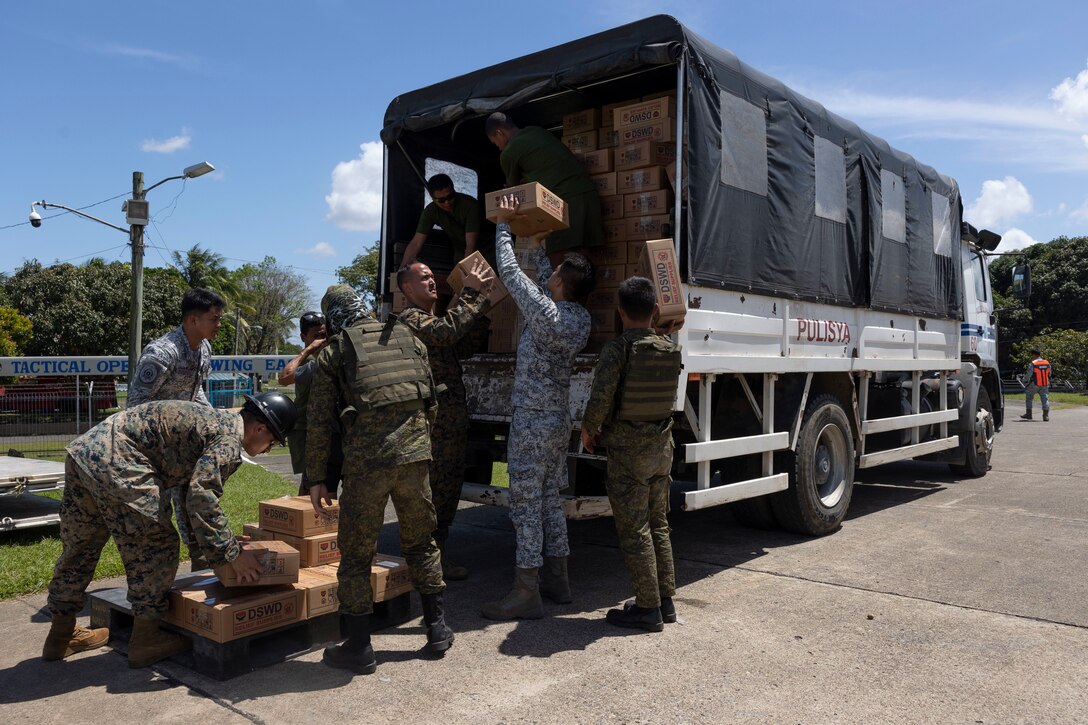 U.S. Marines with 1st Marine Aircraft Wing and Philippine Armed Forces service members load Department of Social Welfare and Development family food packs onto a truck at Davao International Airport, Davao City, Philippines, Feb. 14, 2024. At the request of the Government of the Philippines, the U.S. Marines of III Marine Expeditionary Force are supporting the U.S. Agency for International Development in providing foreign humanitarian assistance to the ongoing disaster relief mission in Mindanao. The forward presence and ready posture of III MEF assets in the region facilitated rapid and effective response to crisis, demonstrating the U.S.’s commitment to Allies and partners during times of need. (U.S. Marine Corps photo by Sgt. Savannah Mesimer)