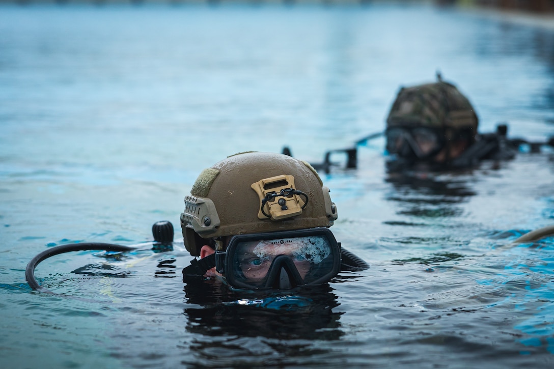 U.S. Marine Corps Cpl. Evan Sheeders emerges from the water during a dive sustainment training on Camp Schwab, Okinawa, Japan, Feb. 8, 2024. The training is designed to enhance the Marines proficiency and capabilities for specialized insert and extract operations. Sheeders, a native of Michigan, is a reconnaissance Marine with 3d Reconnaissance Battalion, 3d Marine Division. (U.S. Marine Corps photo by Lance Cpl. Matthew Morales)