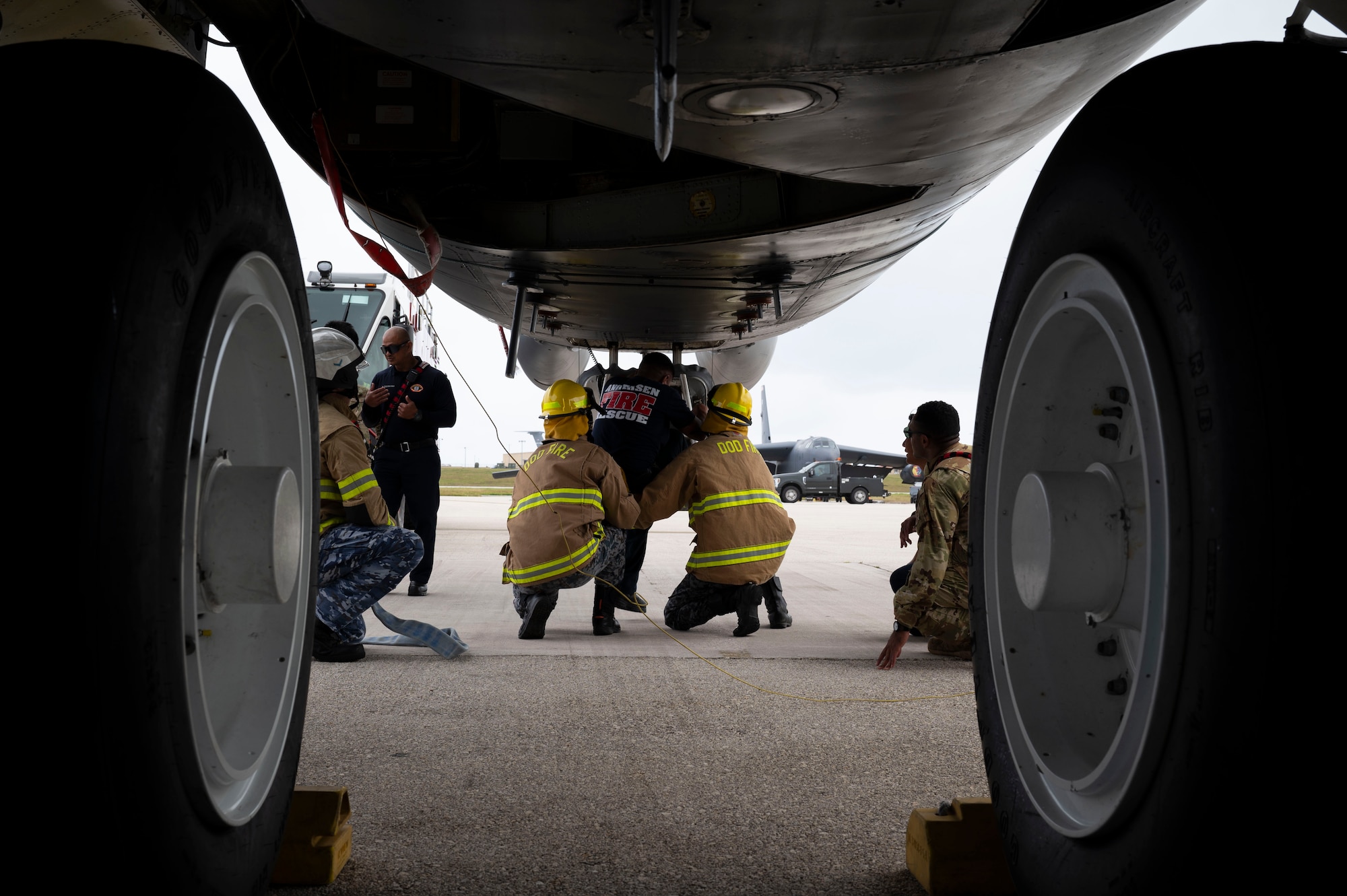 U.S. Air Force, Japan Air Self-Defense Force and Royal Australian Air Force firefighters practice emergency response procedures as part of a trilateral firefighter training during Cope North 24 on Andersen Air Force Base, Guam, Feb. 15, 2024. During the training the USAF firefighters discussed hazards, aircraft entry, engine shut-down procedures and emergency rescue procedures on a B-52 Stratofortress, all of which are vital to secure agile combat employment operations. (U.S. Air Force photo by Airman 1st Class Spencer Perkins)