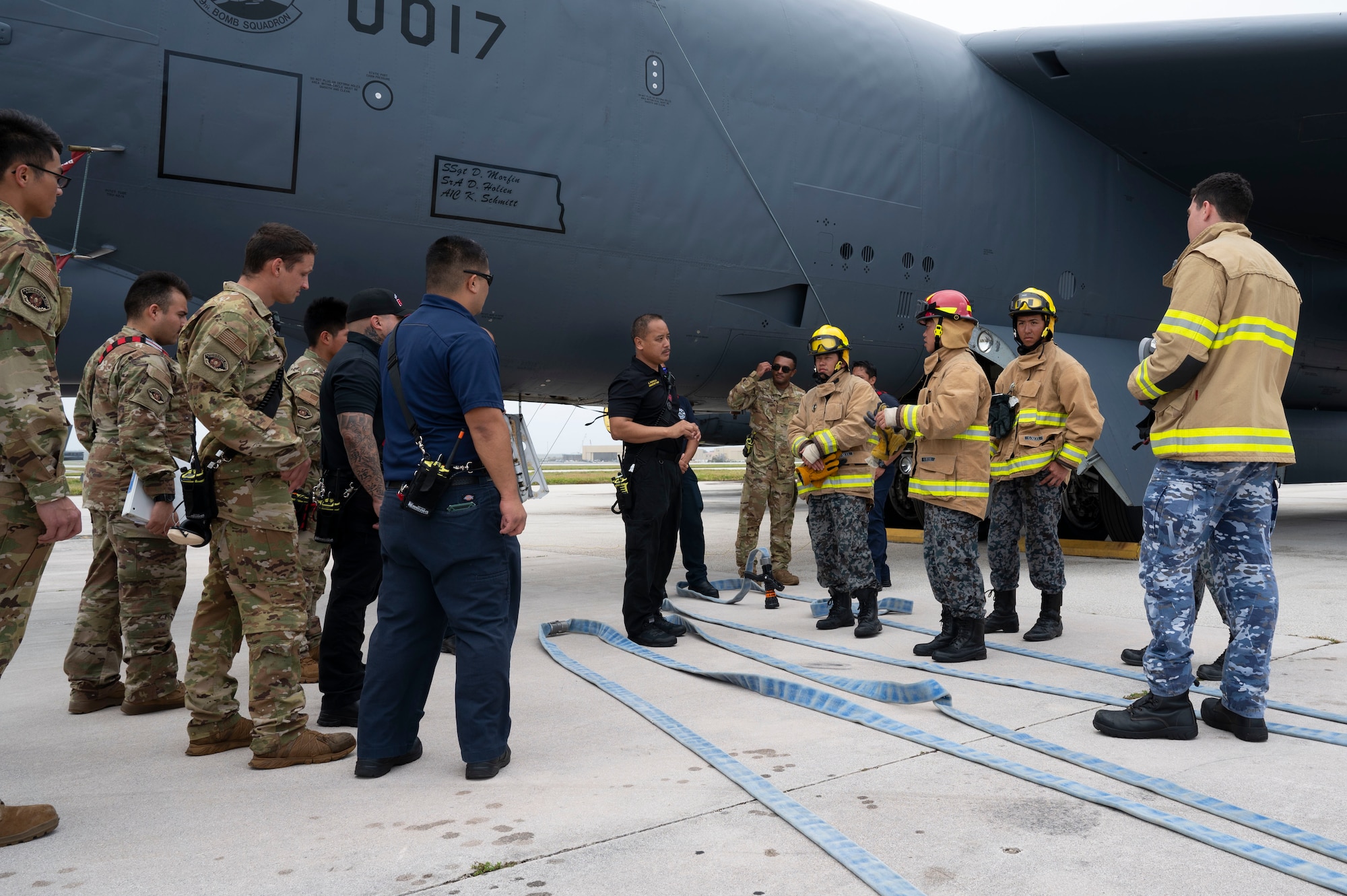 Crispin Pacificar, 36th Civil Engineer Squadron assistant fire chief, briefs members of the U.S. Air Force, Japan Air Self-Defense Force and Royal Australian Air Force on the emergency response procedures as part of a trilateral firefighter training during Cope North 24 on Andersen Air Force Base, Guam, Feb. 15, 2024. During the training the USAF firefighters discussed hazards, aircraft entry, engine shut-down procedures and emergency rescue procedures on a B-52 Stratofortress, all of which are vital to secure agile combat employment operations. (U.S. Air Force photo by Airman 1st Class Spencer Perkins)