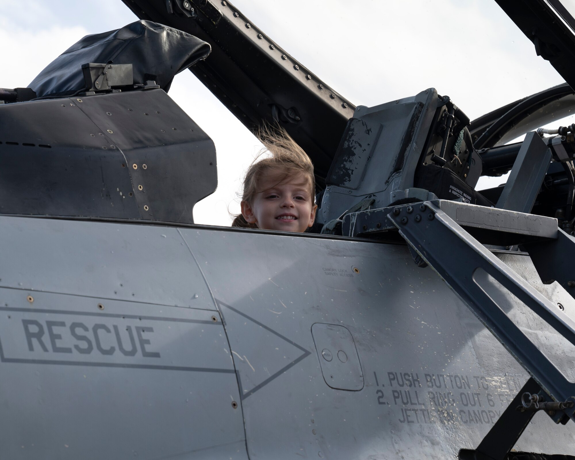 A girl sits in an F-16 Fighting Falcon stationed at Misawa Air Base, Japan during the Cope North 24 static display on Andersen Air Force Base, Guam, Feb. 22, 2024. The static display gave military personnel and families a look at aircraft that had been used during Cope North 24. Exercises like Cope North 24 enable the Joint and combined forces to validate new ways to deploy, maneuver and test new assets. (Airman 1st Class Spencer Perkins)