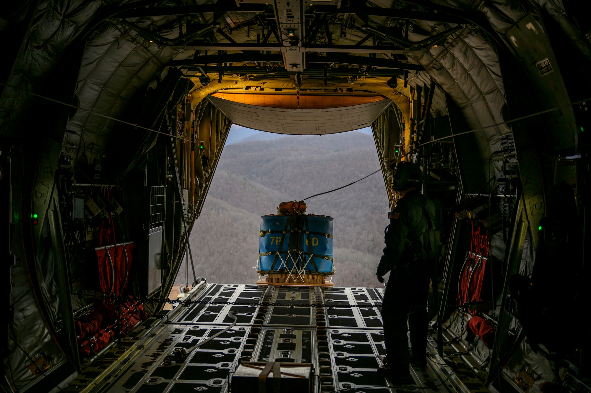 A cargo training pallet drops from a C-130J-30 assigned to the 130th Airlift Wing, McLaughlin Air National Guard Base, W.Va., during routine training over Camp Branch, W.Va., on Feb. 8, 2024. The 130th Airlift Wing performs tactical training throughout the state of West Virginia. (U.S. Air National Guard photo by 2nd Lt. De-Juan Haley)