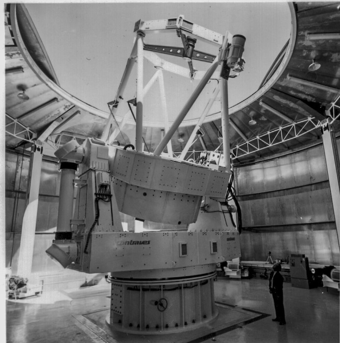 Dr. Robert Q. Fugate stands at telescope at Starfire Optical Range
