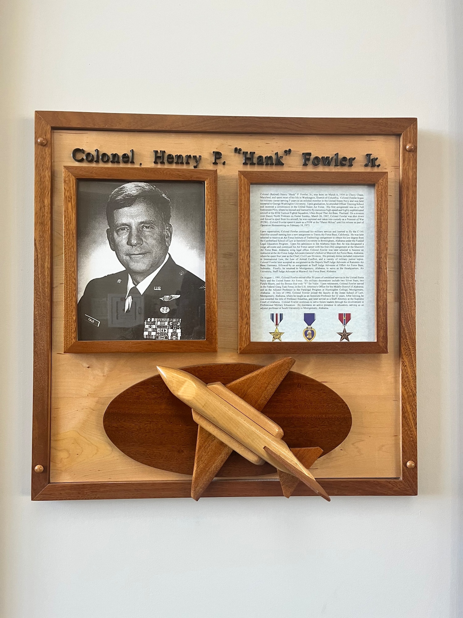 Photo display of Colonel Henry Fowler, USAF, Retired outside of the courtroom which is dedicated in his honor. Fowler’s service to the United States, reflected both his heroism in uniform and his continued selfless support to Maxwell, particularly its core of education and training mission. (Courtesy Photo)