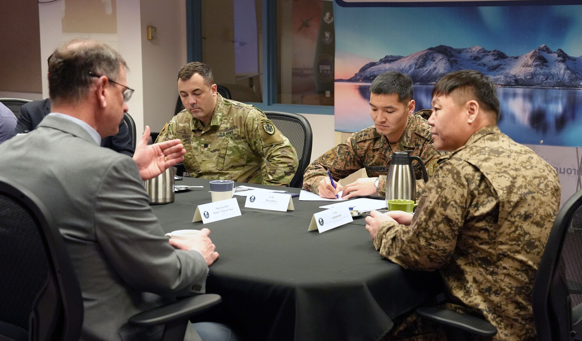 Randy Kee, director of the Ted Stevens Center for Arctic Security Studies, speaks with Col. T. Galbadrakh, deputy chief of the General Staff of the Mongolian Armed Forces, during a visit to the center on Joint Base Elmendorf-Richardson, Alaska, Feb. 14, 2024. Galbadrakh's visit, coordinated through the Department of Defense National Guard Bureau State Partnership Program, underscores the program's evolution into a vital instrument for bolstering U.S. security cooperation on the global stage.