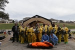 Members assigned to the 17th Medical Group pose for a picture following their Integrated in-place patient decontamination training at Goodfellow Air Force Base, Texas, Feb. 8, 2023. DECON training aims to inform first responders and hospital staff members, who would be the first to respond or provide care, and what steps need to be taken to ensure safety. (U.S. Air Force photo by 2nd Lt. Kayunna Holt)