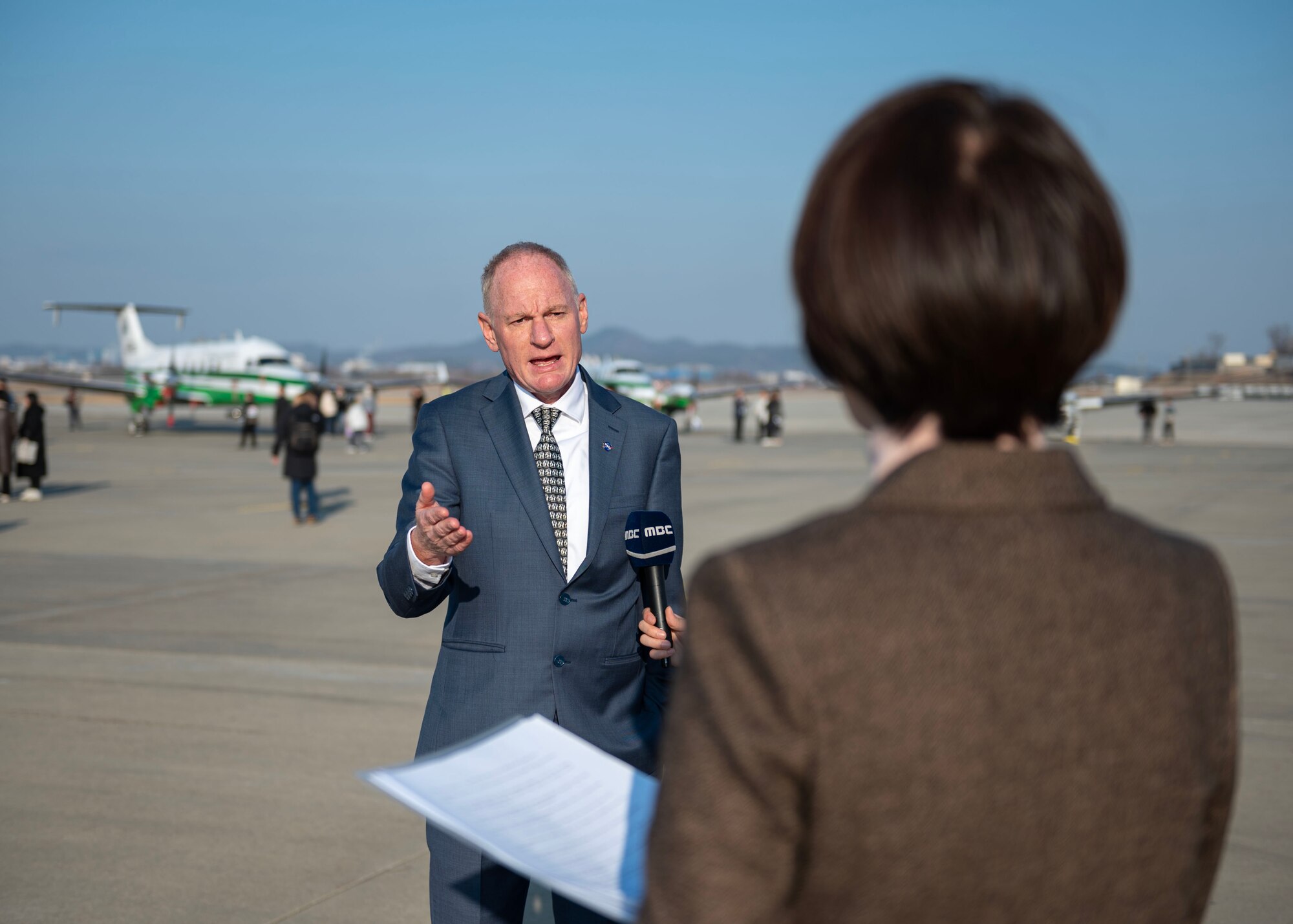 Berry Lefer, NASA tropospheric composition program manager, speaks during an interview with MBC news during the Airborne and Satellite Investigation of Asian Air Quality, or ASIA-AQ, open house at Osan Air Base, Republic of Korea, Feb. 16, 2024. Research flights taken during the ASIA-AQ campaign from ROK were solely conducted from Osan AB. Two NASA science aircraft and four local research aircraft were used, performing multiple flights, and collecting air quality data throughout the campaign. (U.S. Air Force photo by Staff Sgt. Aubree Owens)