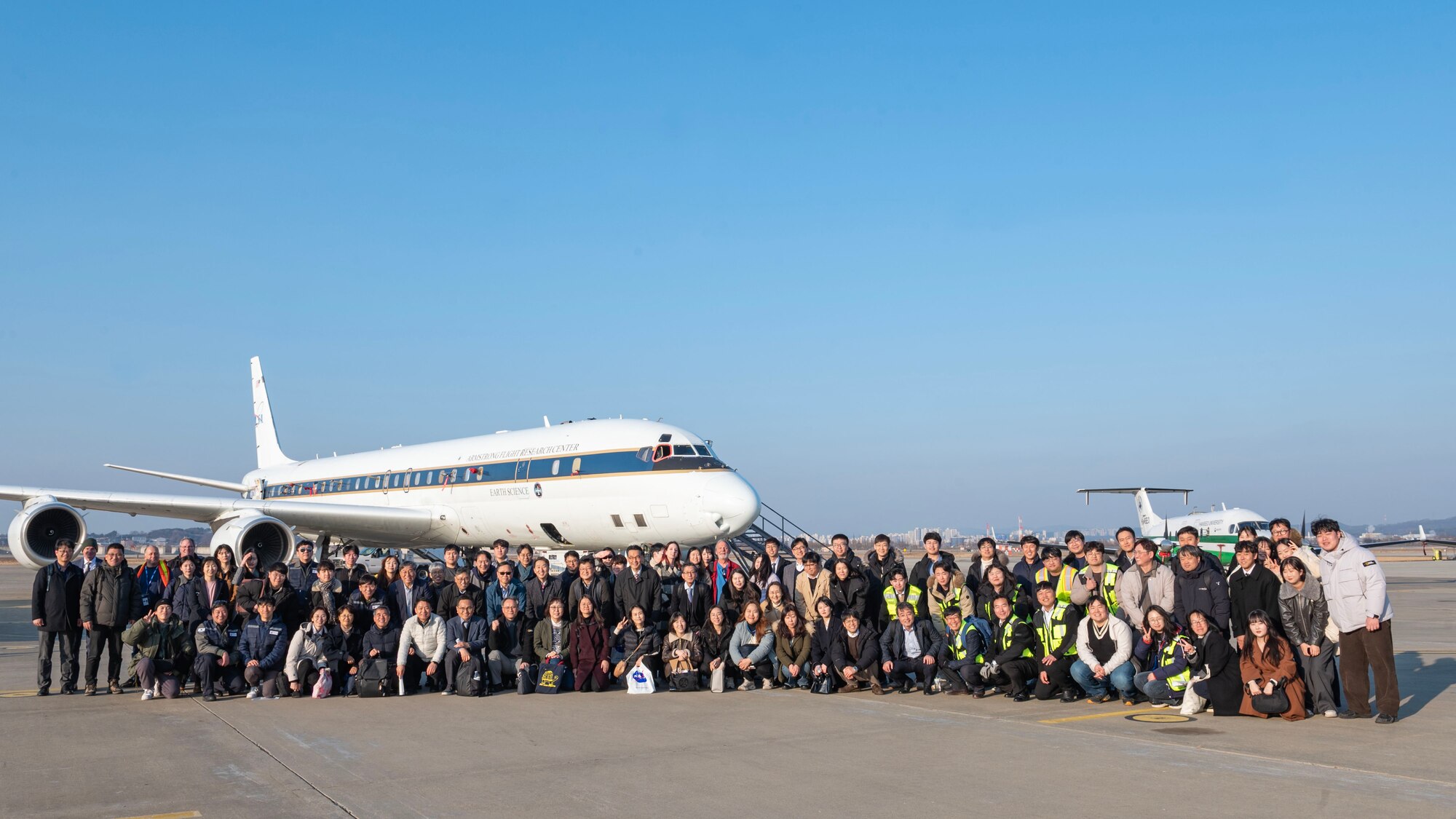 National Aeronautics and Space Administration and National Institute of Environmental Research members take a group photo during the Airborne and Satellite Investigation of Asian Air Quality, or ASIA-AQ, open house at Osan Air Base, Republic of Korea, Feb. 16, 2024. More than 200 participants with ASIA-AQ from NASA, NIER, and other students and researchers held various events at Osan AB allowing subject matter experts to share their efforts in collecting detailed air quality atmospheric data. (U.S. Air Force photo by Staff Sgt. Aubree Owens)