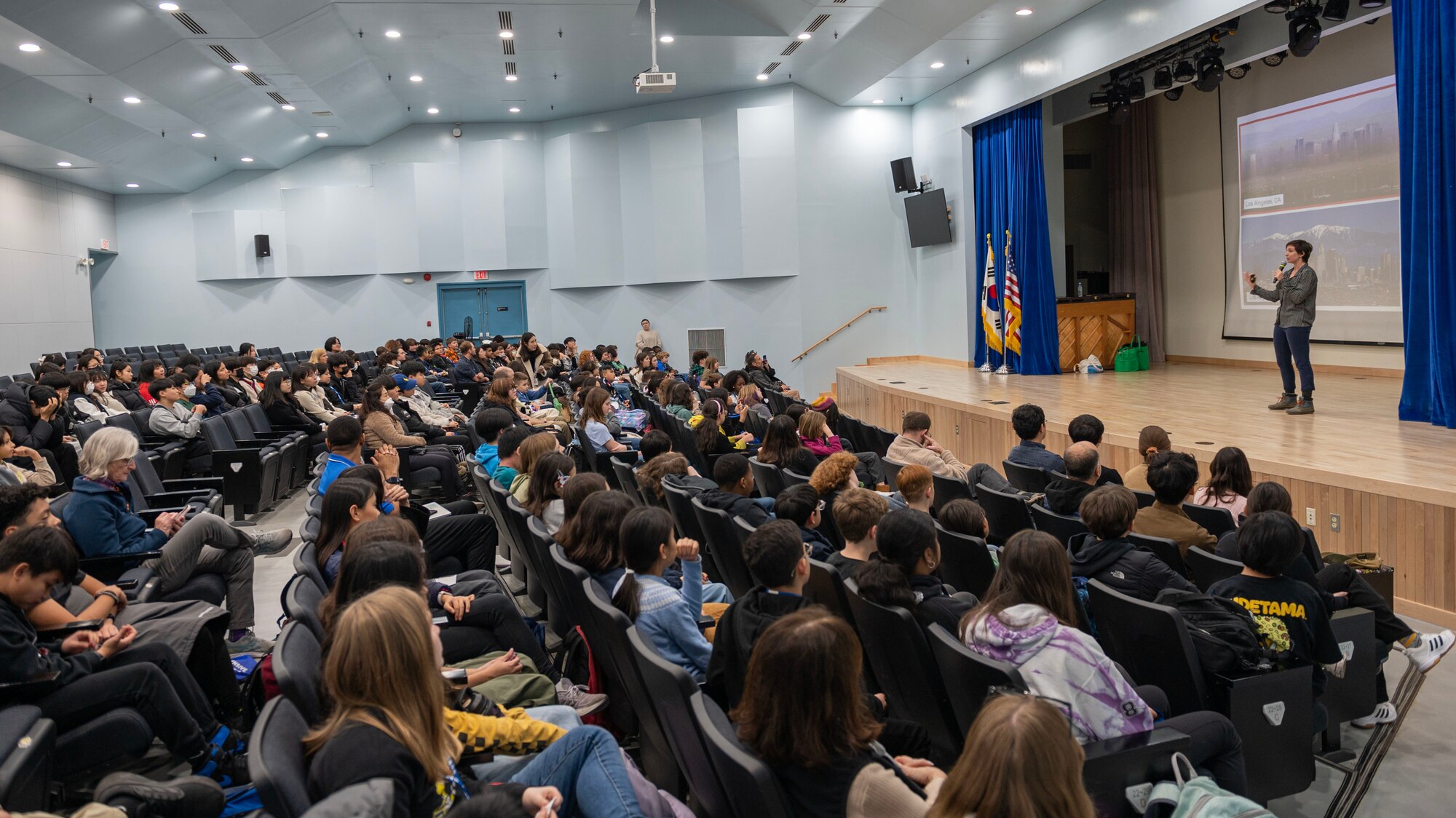 Dr. Brenna Biggs, NASA airborne science program science communications lead, speaks to students from Osan Middle High School and local Korean Nationals during the Airborne and Satellite Investigation of Asian Air Quality, or ASIA-AQ, student engagement at Osan Air Base, Republic of Korea, Feb. 20, 2024. NASA representatives conducted a learning engagement for 120 students from Osan Middle High School and local South Korean Nationals, showing students that anyone can be a scientist, and connected weather to air pollution and reinforced why it matters. (U.S. Air Force photo by Staff Sgt. Aubree Owens)