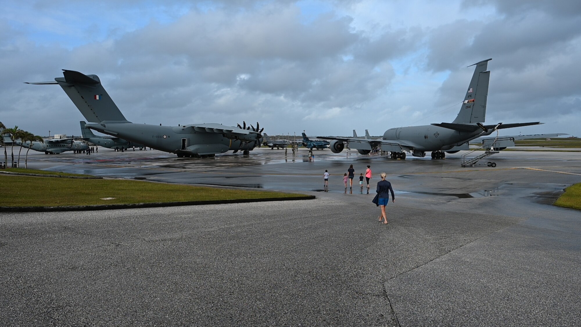 Visitors walk on the flightline.