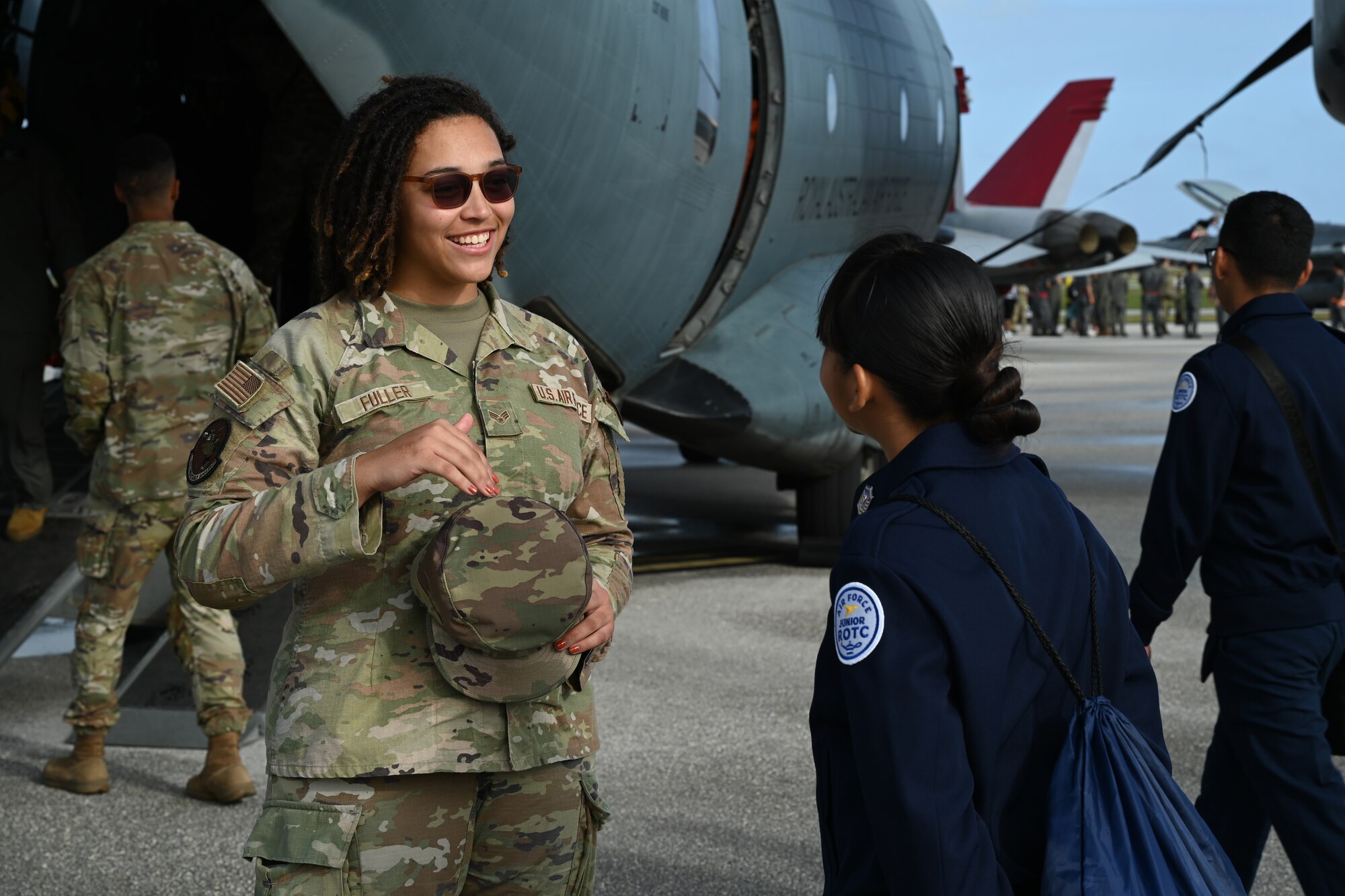 An Airman speaks to a JROTC member.