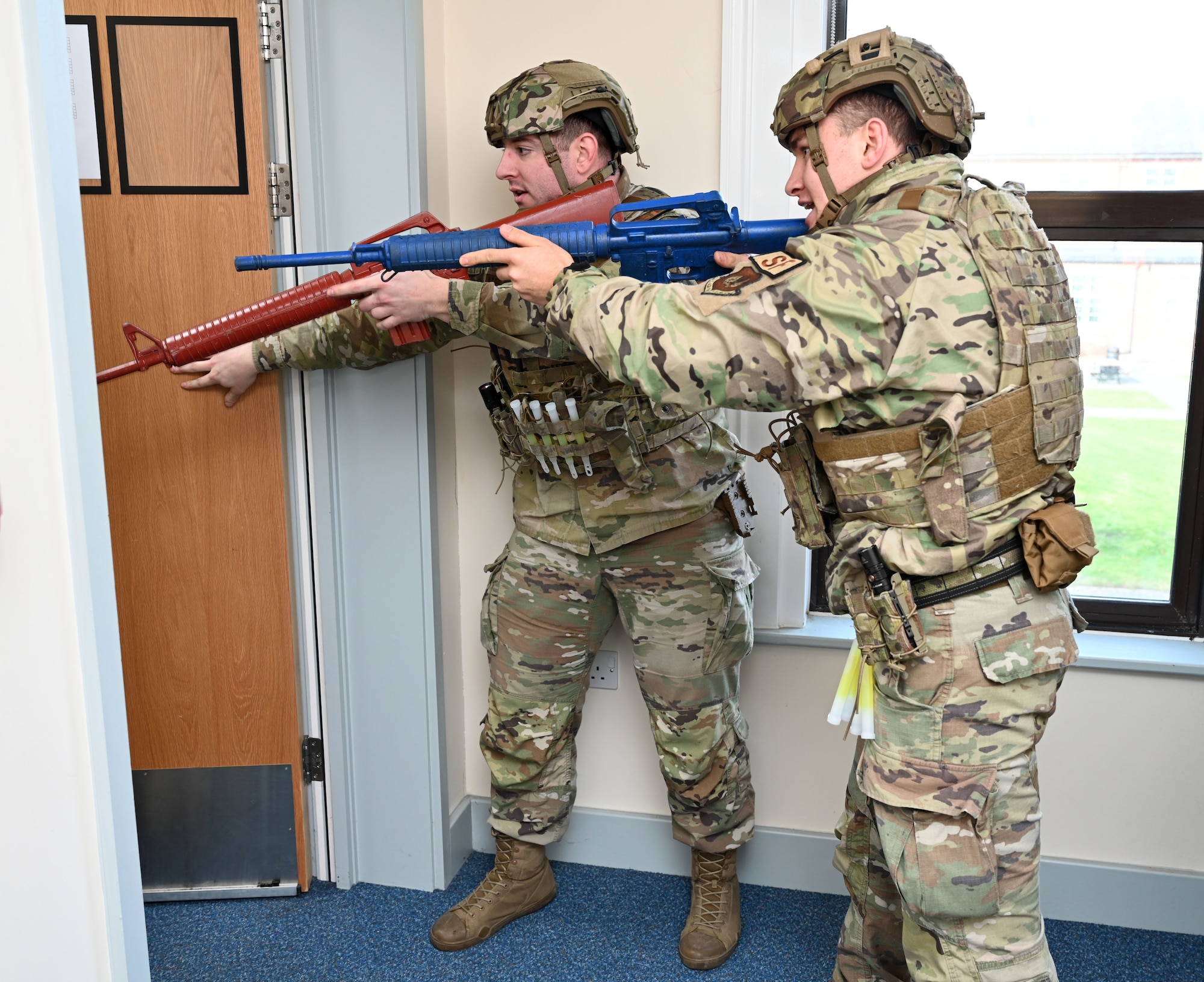 U.S. Air Force 100th Security Forces Squadron defenders clear hallways and prepare to enter a room in search of a simulated active shooter during an exercise at Royal Air Force Mildenhall, England, Feb. 15, 2024. Airmen from the 100th SFS and 100th Civil Engineer Squadron responded to the exercise scenario, which was designed to evaluate the training, readiness and capability of RAF Mildenhall first responders to effectively respond to active shooter threats on the installation. (U.S. Air Force photo by Karen Abeyasekere)