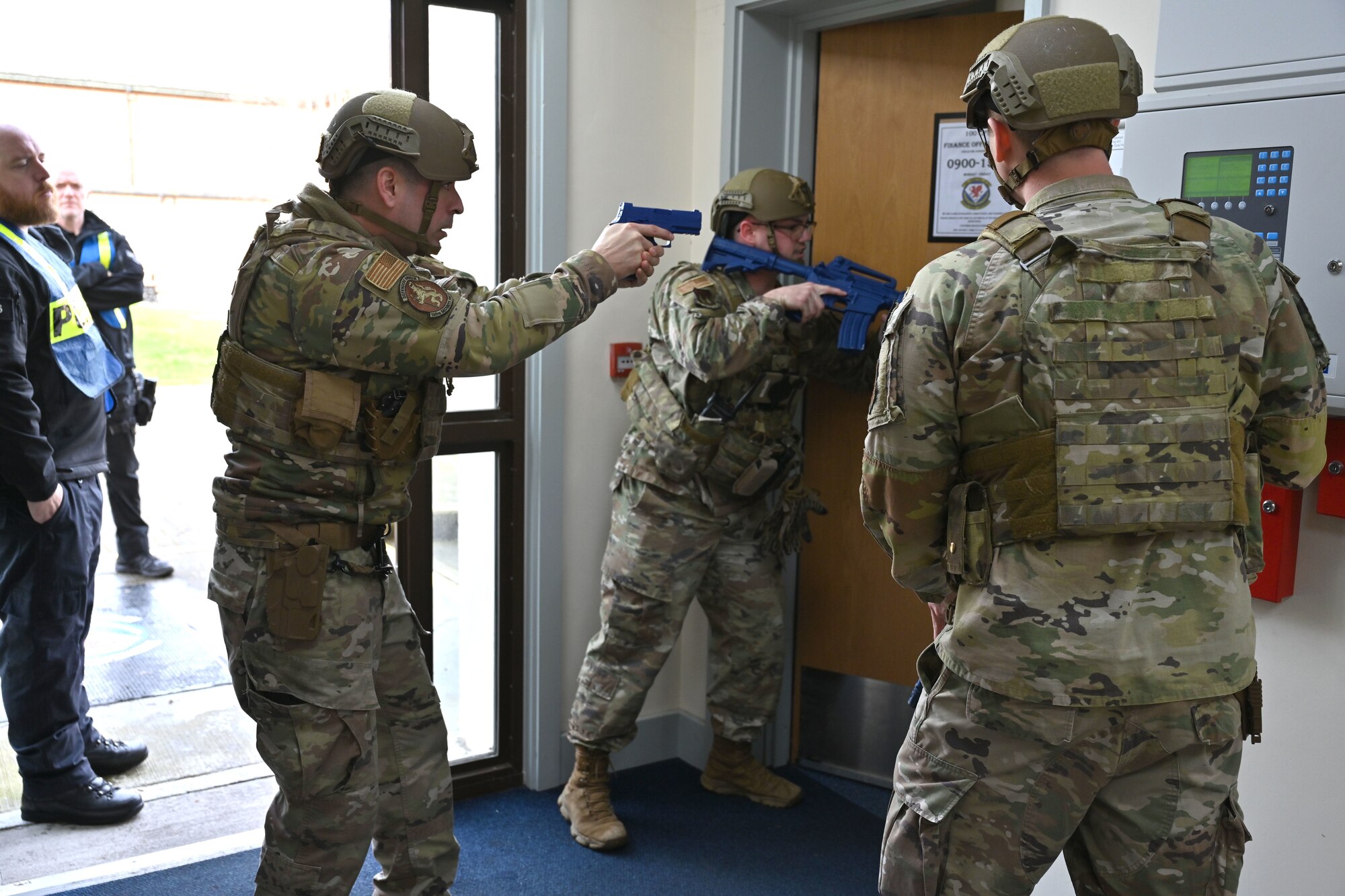 U.S. Air Force 100th Security Forces Squadron defenders prepare to enter a room in search of a simulated active shooter during an exercise at Royal Air Force Mildenhall, England, Feb. 15, 2024. Airmen from squadrons around base volunteered to role-play as casualties and the active shooter, to give a more realistic feel to the exercise and make it more visual for the first responders. (U.S. Air Force photo by Karen Abeyasekere)