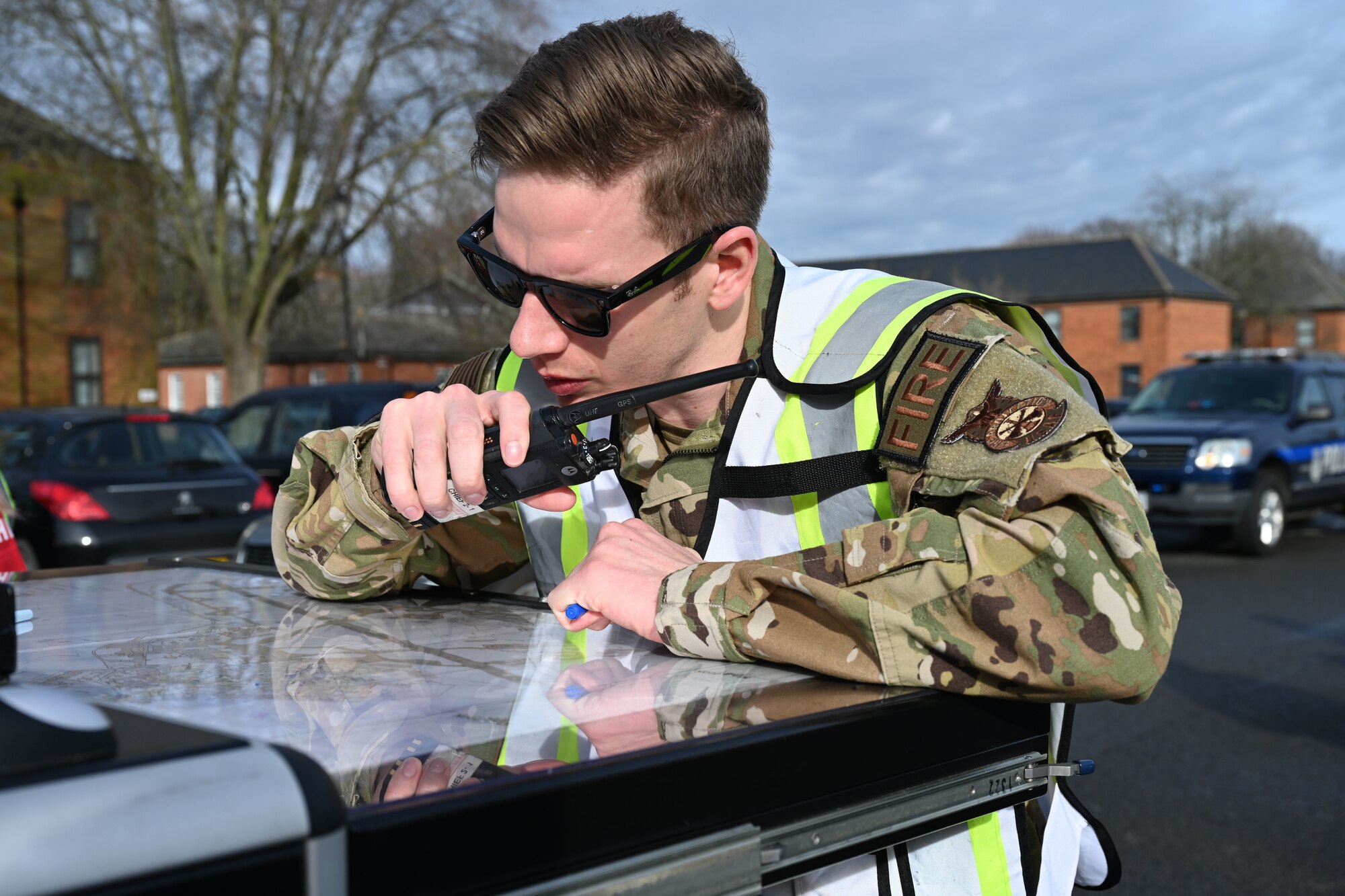 U.S. Air Force Tech. Sgt. John Waddell, 100th Civil Engineer Squadron Fire Department assistant chief of operations, relays locations of entry control points to first responders during an active shooter exercise at Royal Air Force Mildenhall, England, Feb. 15, 2024. In his role of incident commander, Waddell relayed safe routes and advised which roads to block off in the surrounding area. Airmen from squadrons around base volunteered to play as casualties and the active shooter to give a more realistic feel to the exercise and make it more visual for the first responders. The exercise was designed to evaluate the training, readiness and capability of RAF Mildenhall first responders to effectively respond to active shooter threats on the installation. (U.S. Air Force photo by Karen Abeyasekere)