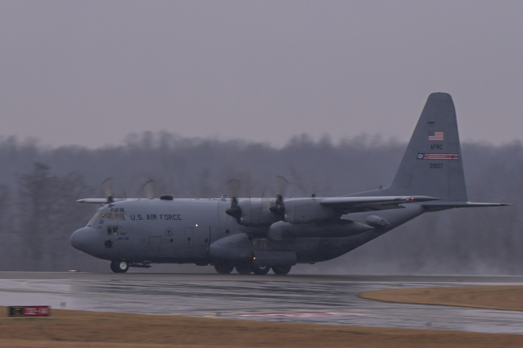 A C-130H Hercules aircraft assigned to the 910th Airlift Wing performs a touch-and-go maneuver on the runway at Youngstown Air Reserve Station, Ohio, Feb. 22, 2024.