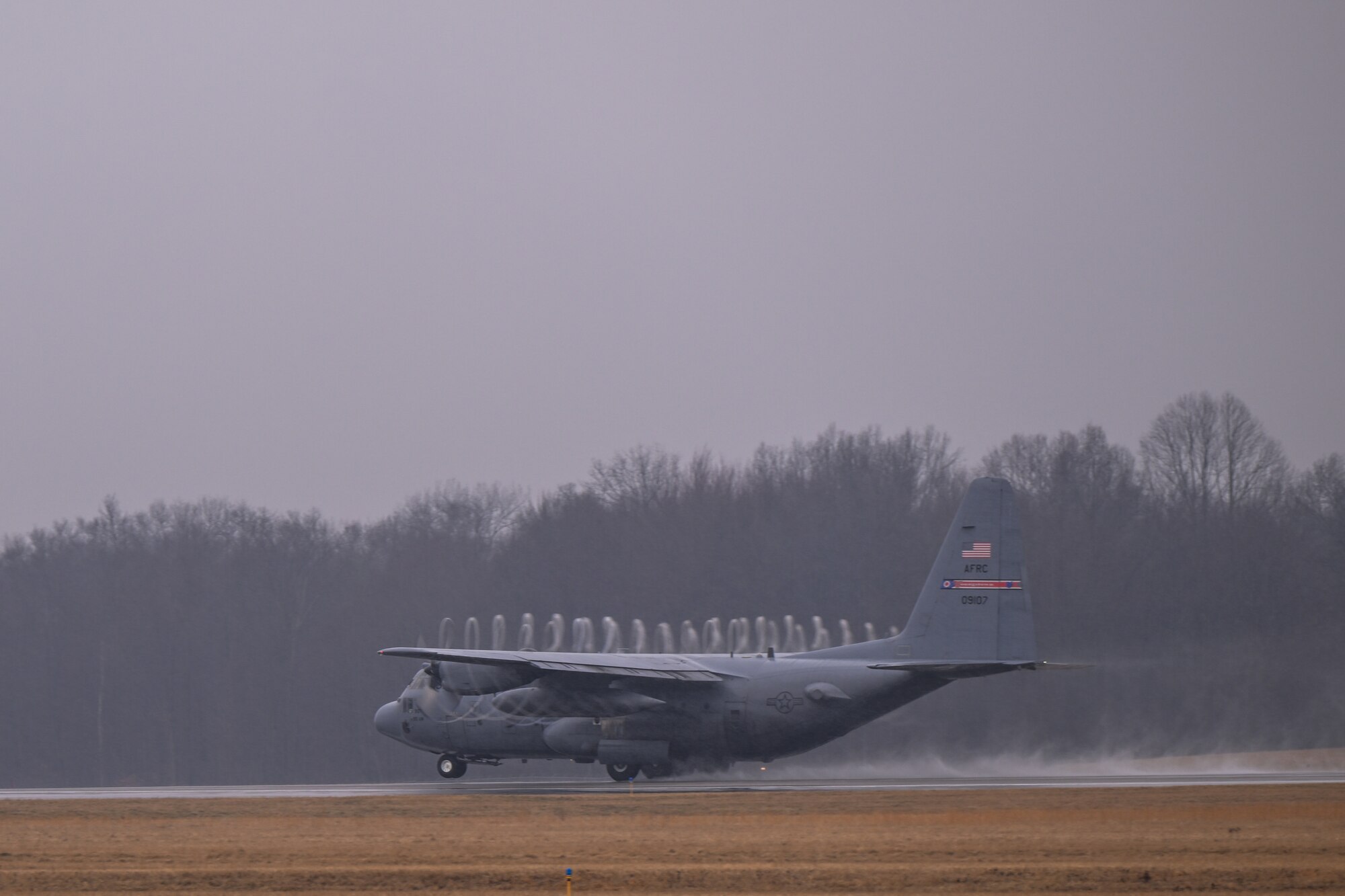 A C-130H Hercules aircraft assigned to the 910th Airlift Wing performs a touch-and-go maneuver on the runway at Youngstown Air Reserve Station, Ohio, Feb. 22, 2024.