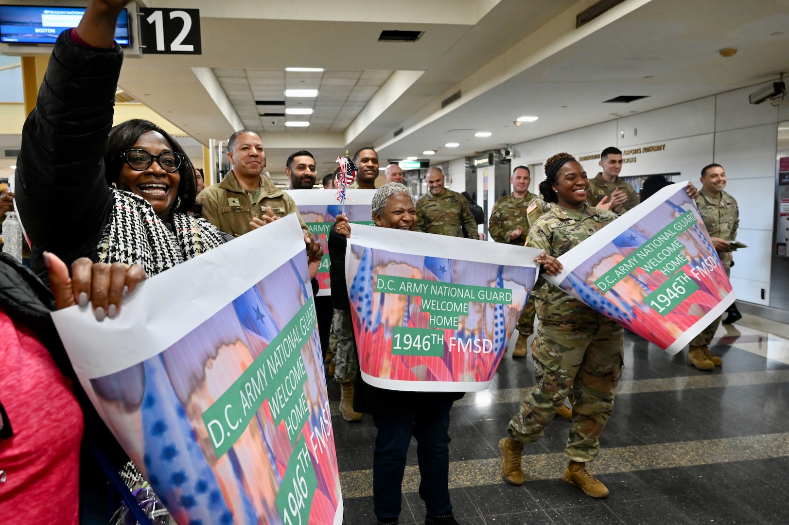 Soldiers with the 1946th Financial Management Support Detachment, District of Columbia National Guard, are greeted by family, friends, senior leadership and D.C. National Guard Family Programs reps at Ronald Reagan Washington National Airport, Feb. 16, 2024. Guard members returned from a nine-month deployment to Camp Bondsteel, Kosovo, providing financial management support to Kosovo Forces assigned to the NATO peacekeeping mission.