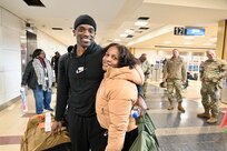 Soldiers with the 1946th Financial Management Support Detachment, District of Columbia National Guard, are greeted by family, friends, senior leadership and D.C. National Guard Family Programs reps at Ronald Reagan Washington National Airport, Feb. 16, 2024. Guard members returned from a nine-month deployment to Camp Bondsteel, Kosovo, providing financial management support to Kosovo Forces assigned to the NATO peacekeeping mission.