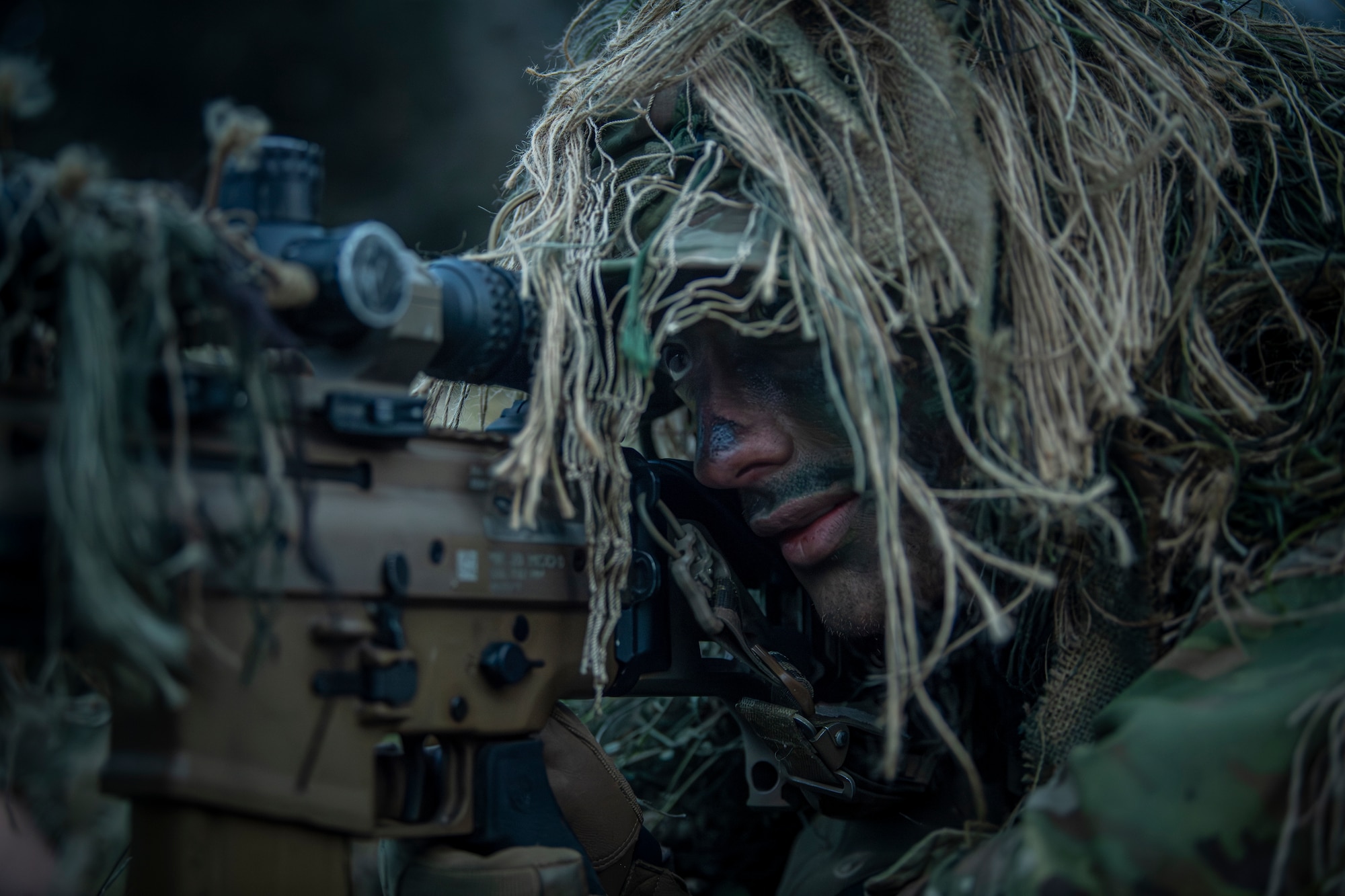 Staff Sgt. Aaron Weaver, a 14th Air Support Operations Squadron tactical air control party craftsman, aims down his SCAR MK 20 sniper support rifle scope