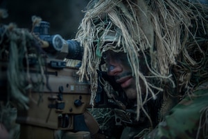 Staff Sgt. Aaron Weaver, a 14th Air Support Operations Squadron tactical air control party craftsman, aims down his SCAR MK 20 sniper support rifle scope
