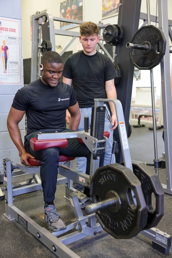 U.S. Marine Corps Sgt. Paul Nhomba, left, mobility chief with the Marine Corps Warfighting Laboratory, sets the example for Pfc. Kaden Maddox, a logistics specialist with MCWL, during a physical training session at the Barber Physical Activity Center, on Marine Corps Base Quantico, Va., Feb. 2, 2024. Nhomba was born and raised in Cameroon; shortly after moving to the U.S., he achieved full citizenship while serving in the U.S. Marine Corps. Nhmoba is described by Maddox as one who “leads by example and won’t ask someone to do anything that he wouldn’t do himself.” (U.S. Marine Corps photo by Sgt. Levi Voss)