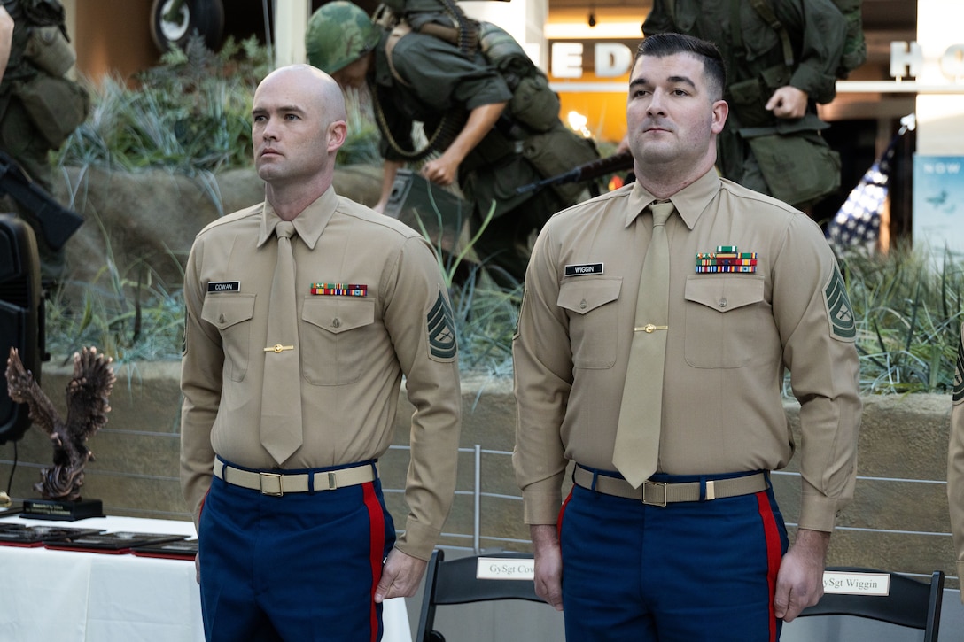 U.S. Marine Corps Gunnery Sgt. Russell B. Cowan, left, a recruiter with Recruiting Station San Diego, Calif., 12th Marine Corps District, and Gunnery Sgt. Tristan Wiggin, right, a recruiter with Recruiting Station Tampa, Fl., 6th Marine Corps District stand by to receive the award for Recruiter of the Year and First Runner-up, respectively, at the National Museum of The Marine Corps, Triangle, Va., February 8, 2024. The award was given to recognize the best of those who scour the nations landscape seeking out those who will take their place upon the yellow footprints. (U.S. Marine Corps photo by Sgt. Rachaelanne Woodward)
