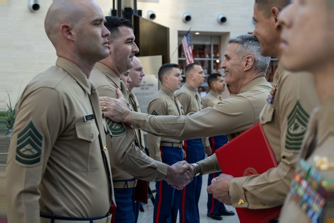 U.S. Marine Corps Gunnery Sgt. Tristan Wiggin, a recuiter with Recruiting Station Tampa, Fl., 6th Marine Corps District, receives the award for First Runner-up Recruiter of the Year from General Christopher J. Mahoney, the 37th assistant commandant of the Marine Corps, at the National Museum of The Marine Corps, Triangle, Va., February 8, 2024. The award was given to recognize the best of those who scour the nations landscape seeking out those who will take their place upon the yellow footprints. (U.S. Marine Corps photo by Sgt. Rachaelanne Woodward)