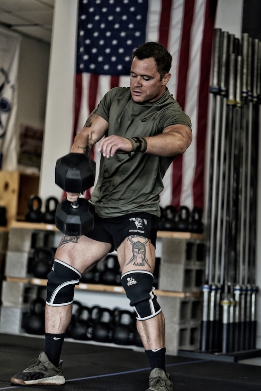 A soldier lifts weights.