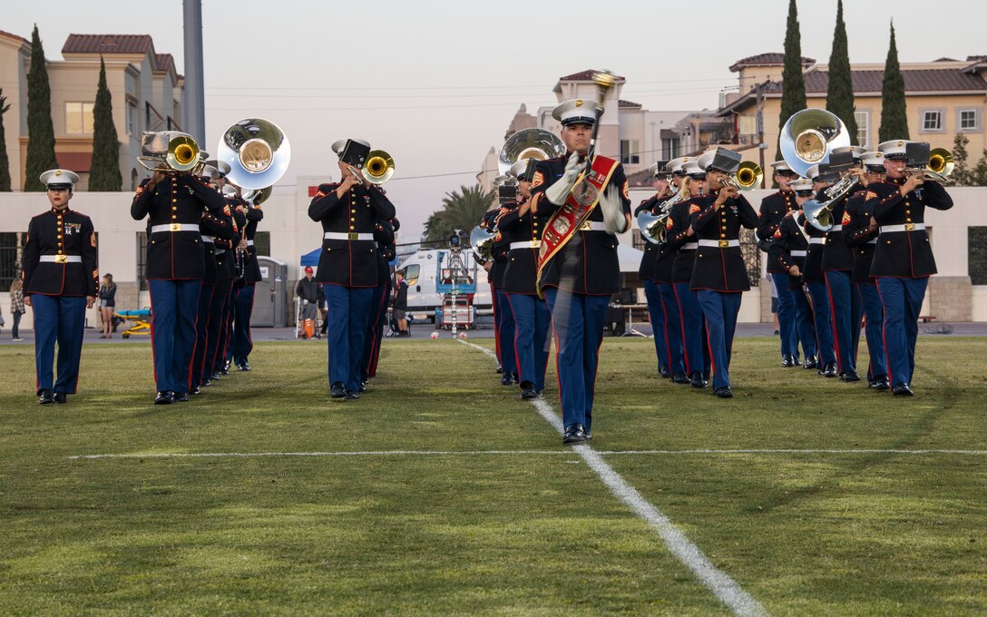 U.S. Marines with Headquarters Company, Headquarters and Service Battalion, and members of Marine Band San Diego, perform a half-time show for San Diego State University during a rugby game in San Diego, California, May 15, 2022. The band is active in providing clinics and concerts for high school and college students throughout the western United States; serving as musical role models for developing musicians. (U.S. Marine Corps photo by Cpl. Julian Elliott-Drouin)