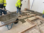 Prepping the floor to slope the floor and establish a drain.