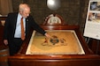 Dennis Boylan, an honorary captain who served as First Troop Philadelphia City Cavalry’s commander from 1983 to 1988, points out a feature of the troop's original standard, which dates to 1775, in the museum inside the troop's armory in Philadelphia. (Pennsylvania National Guard photo by Brad Rhen)