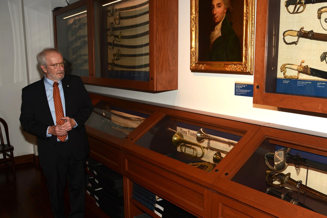 Dennis Boylan, an honorary captain who served as First Troop Philadelphia City Cavalry’s commander from 1983 to 1988, discusses artifacts in the museum inside the troop's armory in Philadelphia. (Pennsylvania National Guard photo by Brad Rhen)