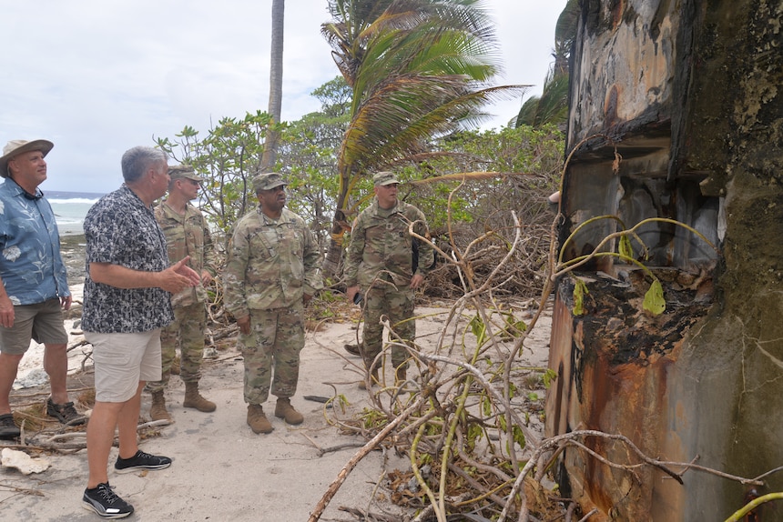 Sgt. Maj. Frederick Haerter, Jr., Col. Andrew Morgan, Maj. Gen. Reginald Neal, Dr. Michael Krivdo and Dr. Timothy Francis at site of Japanese bunker, Nadine Point, Namur Island. Author photo.