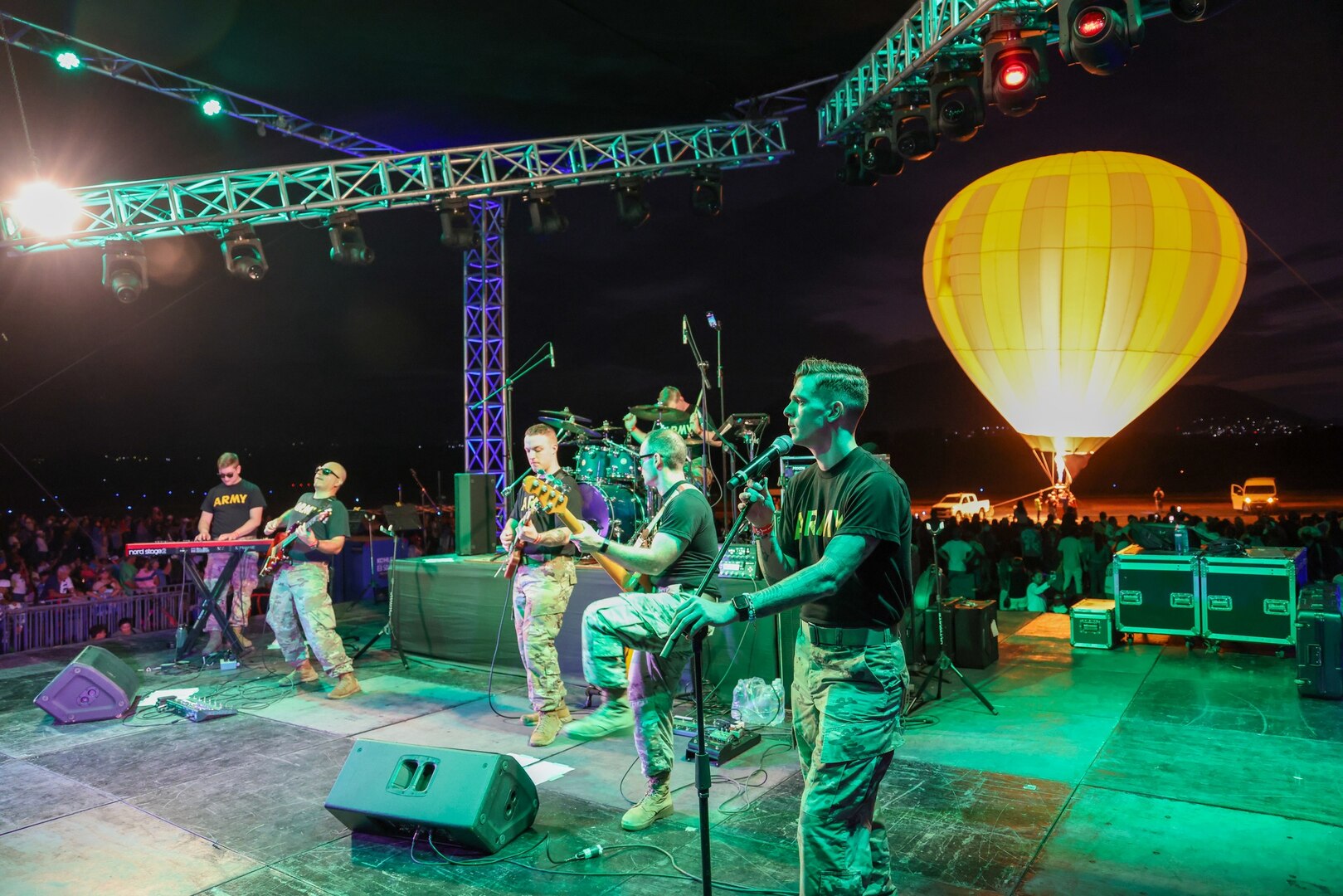 The 39th Army Band, 54th Troop Command, New Hampshire Army National Guard, plays with a hot air balloon pulsing flames at the Ilopango Air Show in El Salvador on Feb. 18, 2024.