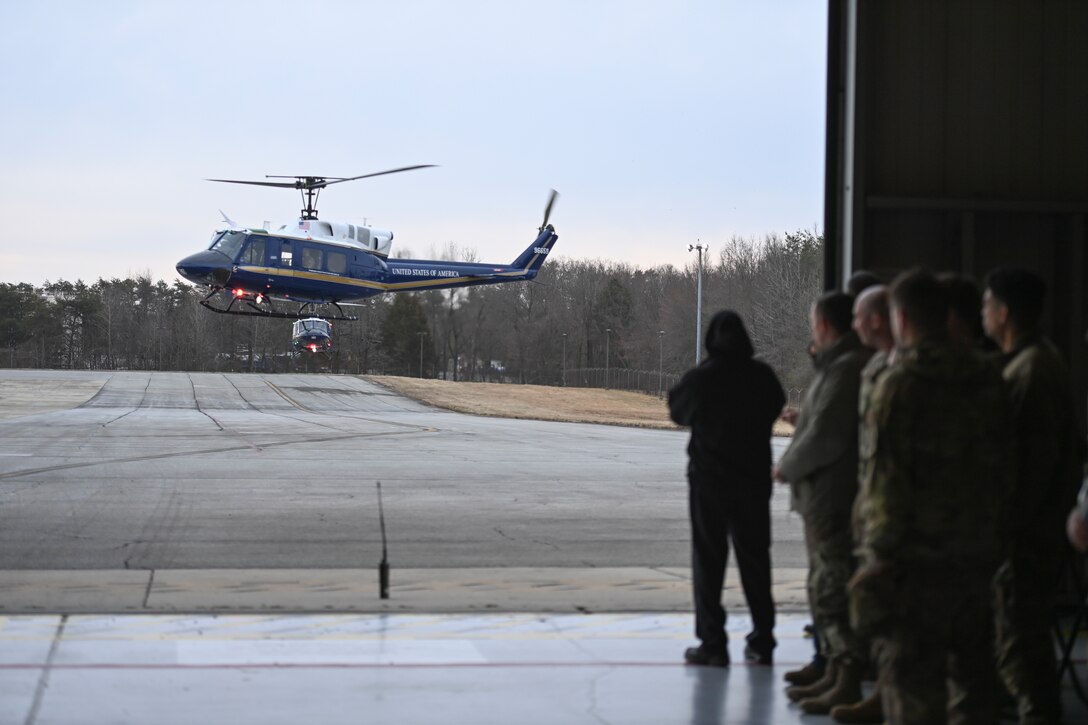 UH-1N Huey helicopter arrives to flight light outside of hanger.