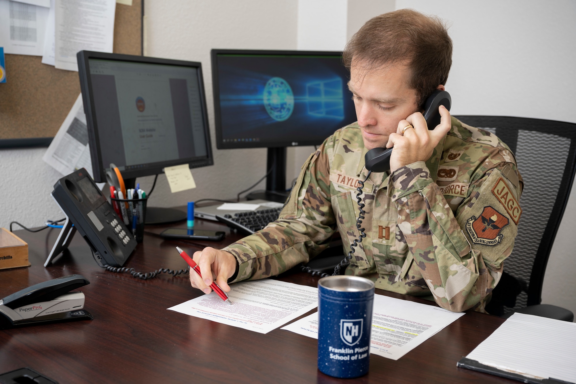 U.S. Air Force Capt. Duncan Taylor, 49th Wing Judge Advocate chief of legal assistance and operations law, reviews legal guidelines in his office at Holloman Air Force Base, New Mexico, Feb. 12, 2024. Taylor and his colleagues assist Airmen with a variety of legal matters by appointment and walk-in visits. (U.S. Air Force photo by Airman 1st Class Bob Teichmann)
