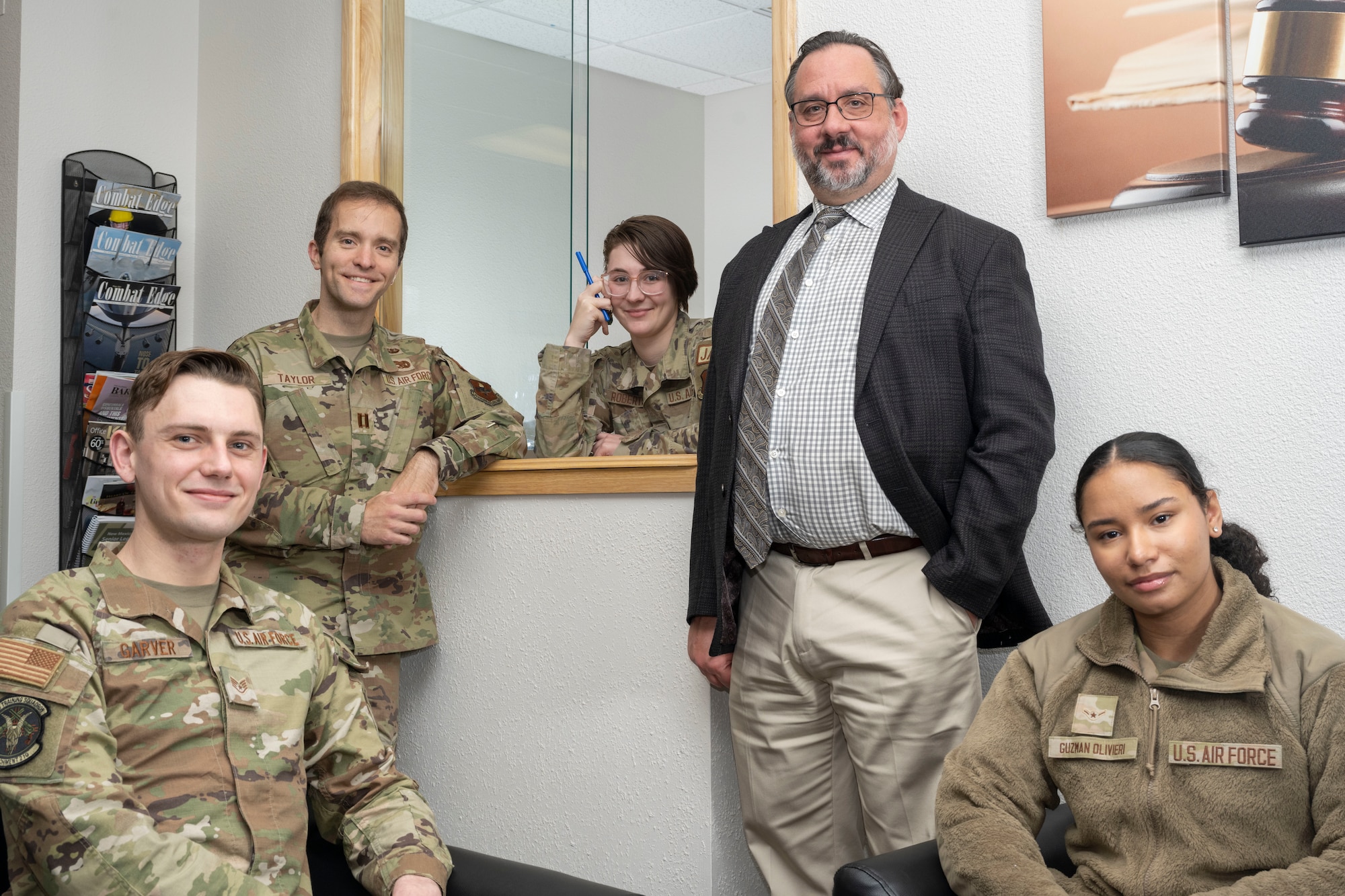 Members of the 49th Wing Judge Advocate office pose for a photo in their customer lobby at Holloman Air Force Base, New Mexico, Feb. 13, 2024. Airmen who need legal service are able to make appointments or walk in for assistance with notarizations, landlord disputes, immigration advice, and more. (U.S. Air Force photo by Airman 1st Class Bob Teichmann)