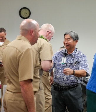 Joint Task Force-Red Hill (JTF-RH) Commander, U.S. Navy Vice Adm. John Wade receives a traditional Hawaii flower lei from Manager and Chief engineer of the Board of Water Supply, Ernest Y. W. Lau at the Defueling Information Sharing Forum, Feb. 22, 2024 at the Hawaii State Capitol, Honolulu, Hawaii.