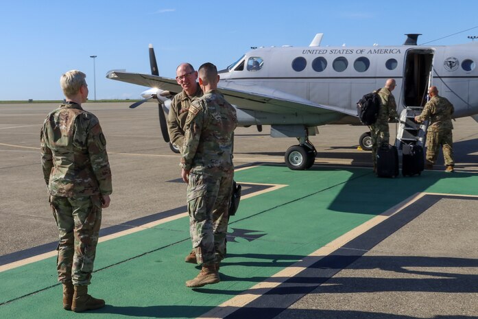 U.S. Air Force Gen. Duke Z. Richardson, Air Force Materiel Command commander, greets Col. Geoffrey Church, 9th Reconnaissance Wing commander, and Command Chief Master Sgt. Breana Oliver, 9th Reconnaissance Wing command chief, Feb. 22, 2024, at Beale Air Force Base, California.