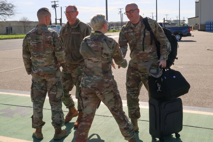 U.S. Air Force Gen. Duke Z. Richardson, Air Force Materiel Command commander (left), talks to Col. Geoffrey Church, 9th Reconnaissance Wing commander, while Command Chief Master Sgt. Breana Oliver, 9th Reconnaissance Wing command chief, greets Command Chief Master Sgt. James Fitch, Air Force Materiel Command command chief, Feb. 22, 2024, at Beale Air Force Base, California.