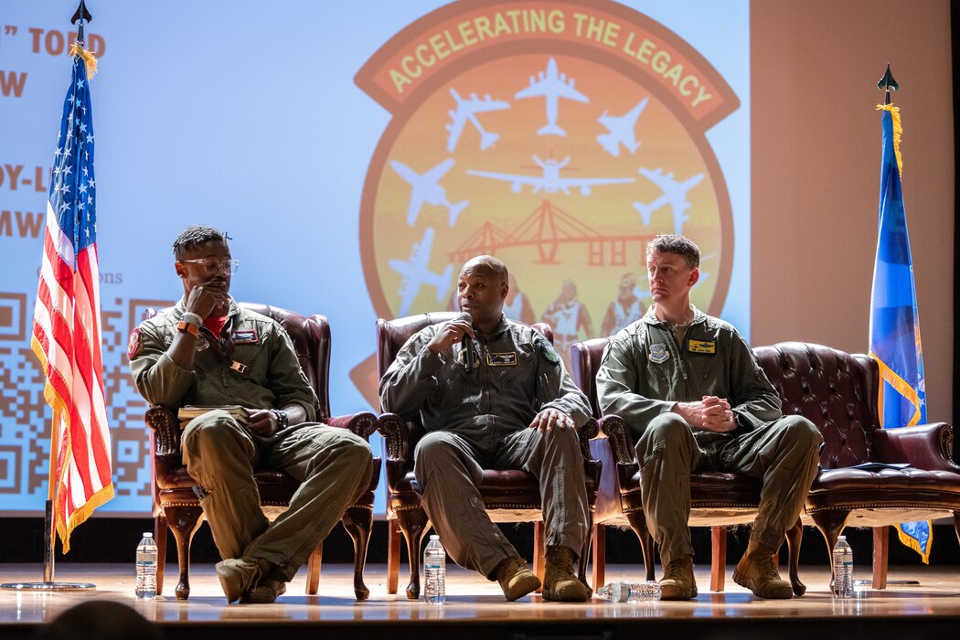 Three Airmen sit on a stage during the Accelerating the Legacy event at Joint Base Charleston, South Carolina, Feb. 16, 2024.