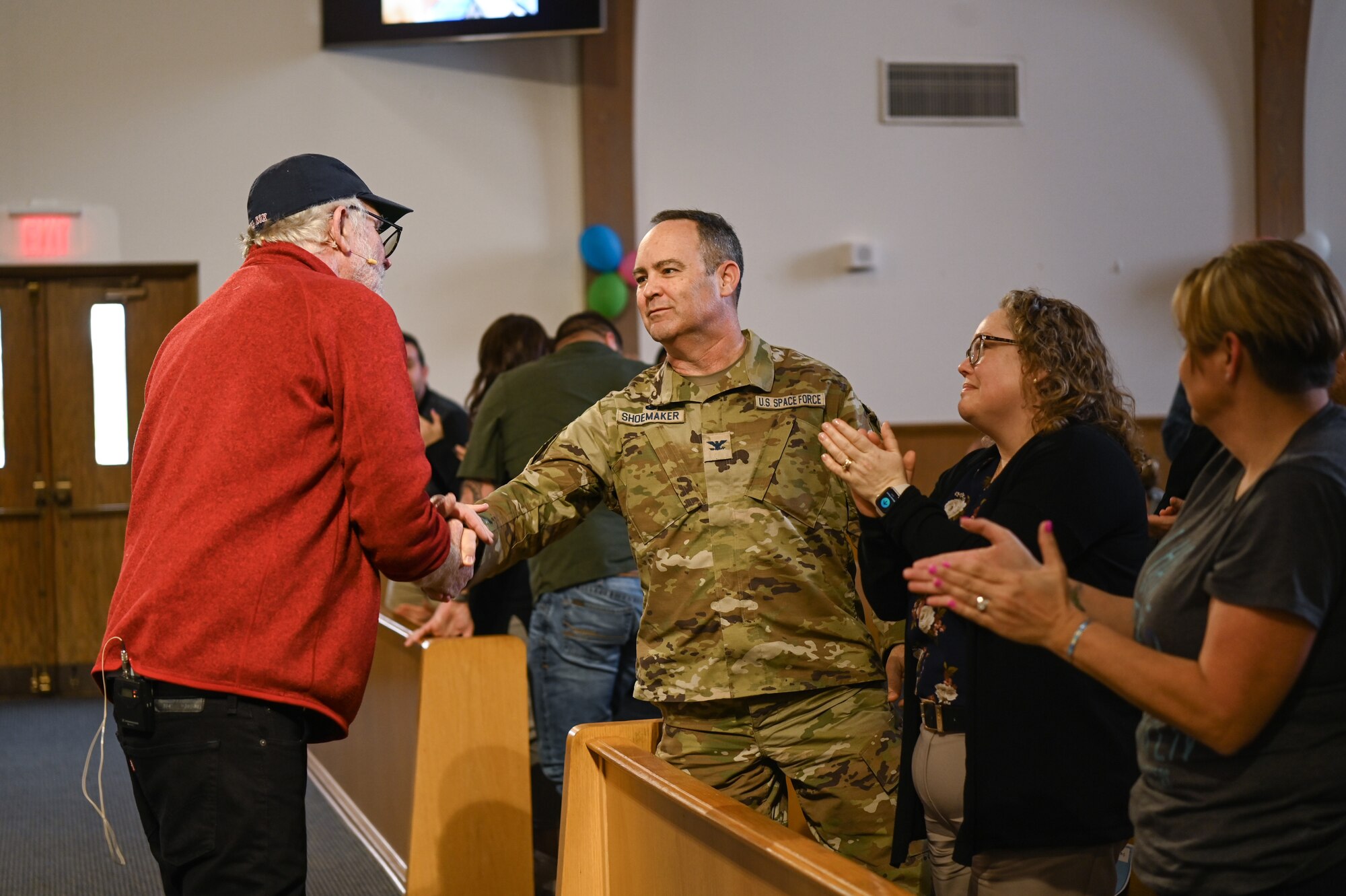 Space Launch Delta 30 commander, along with his wife and Hawk’s Cove Resilience Operation Center integrated prevention and response director, greets Robert Goff, an author, during a Chapel event at Vandenberg Space Force.