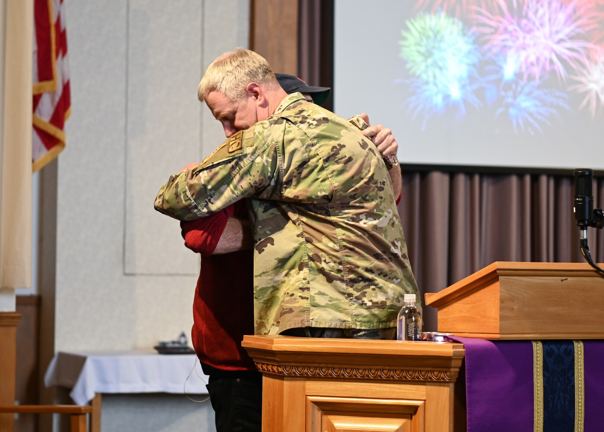 30th Chaplain Corps chaplain, embraces American lawyer, speaker and author, in a hug during a Chapel event at Vandenberg Space Force Base.