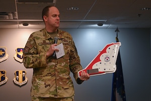 Col. Denny Davies, 19th Airlift Wing and installation commander, displays the Thunderbirds’ Military Air Show of the Year award to the Little Rock Air Force Base Community Council at Little Rock Air Force Base, Arkansas, Feb. 22, 2024. The Community Council’s contributions were instrumental to the success of “Thunder Over the Rock,” Little Rock AFB’s first air show in five years. (U.S. Air Force photo by Airman 1st Class Saisha Cornett)