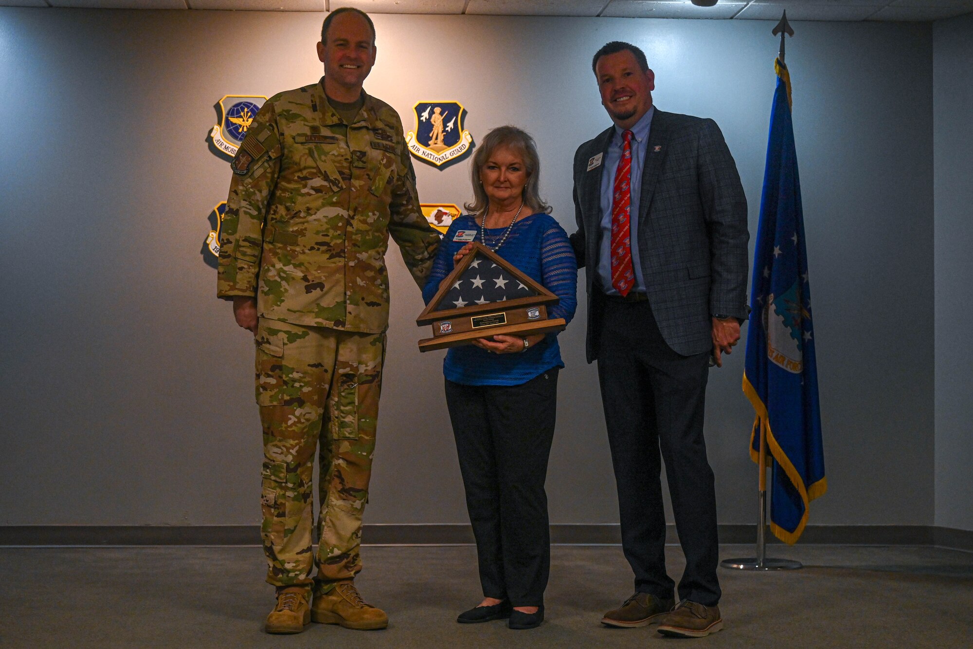 Col. Denny Davies, 19th Airlift Wing and installation commander, and Daniel Gray, Little Rock Air Force Base Community Council president, present Annabelle Davis, Little Rock AFB Community Council outgoing executive secretary, with a farewell gift at Little Rock Air Force Base, Arkansas, Feb. 22, 2024. Davis is retiring from her position after 35 years of service to the Little Rock AFB community. (U.S. Air Force photo by Airman 1st Class Saisha Cornett)